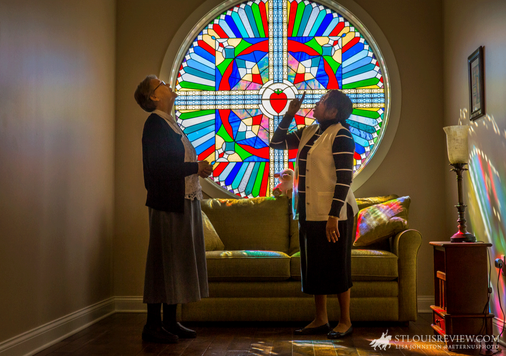 Sister Ita Harnett, postulant director for the Sisters of Charity of the Incarnate Word novitiate in St. Louis, looked at the colors coming off the stained glass with formation director Sister Helena Adaku Ogbuji. The Sisters of Charity recently completed consolidation of novitiates from Kenya and Guatemala into the novitiate in St. Louis.