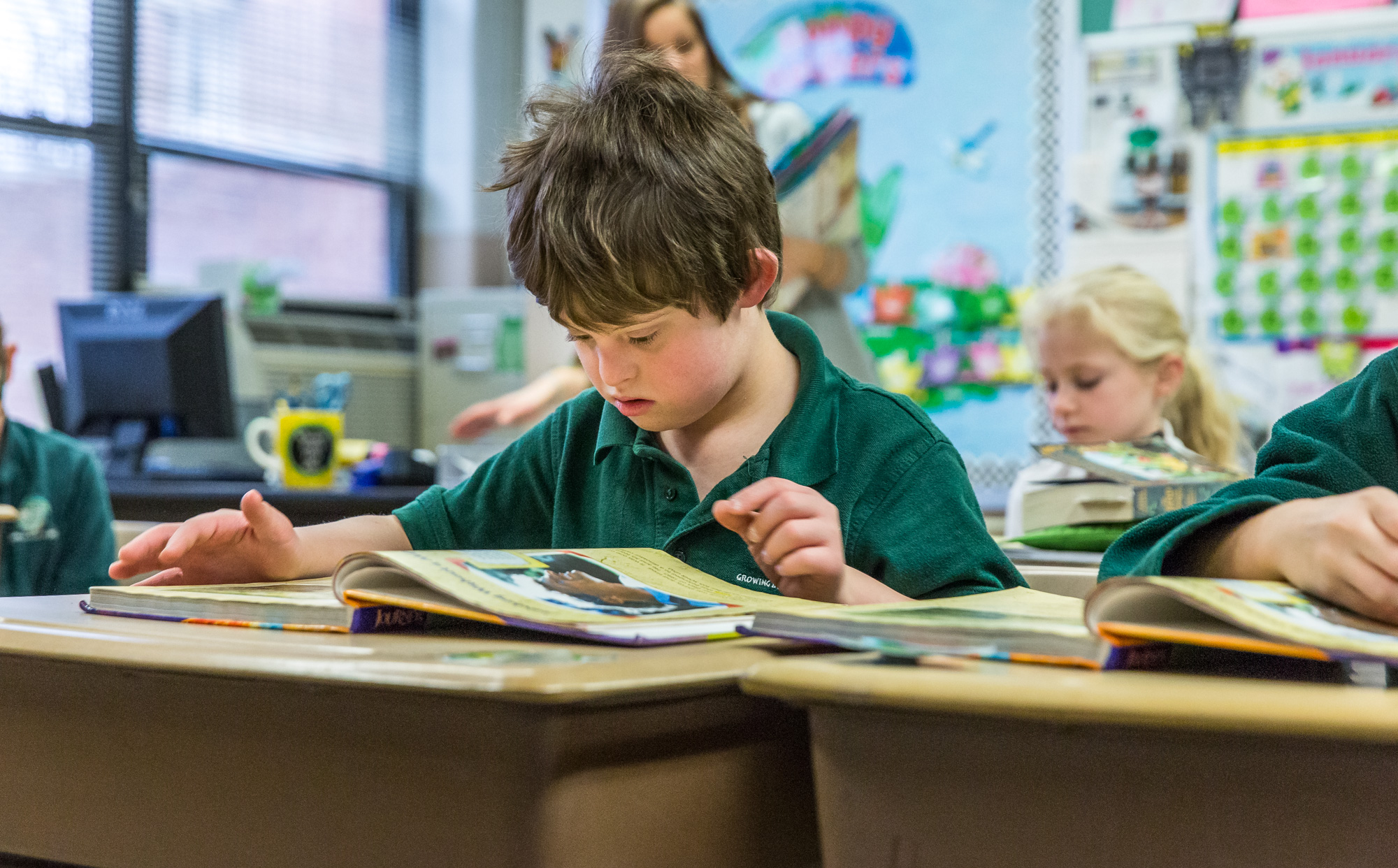 Third-grader Aiden Hadican read with his classmates Jan. 23 at
Incarnate Word School. After careful study over the past three
years, Incarnate Word School began an inclusion program,
accepting three students with Down Syndrome, including Aiden.