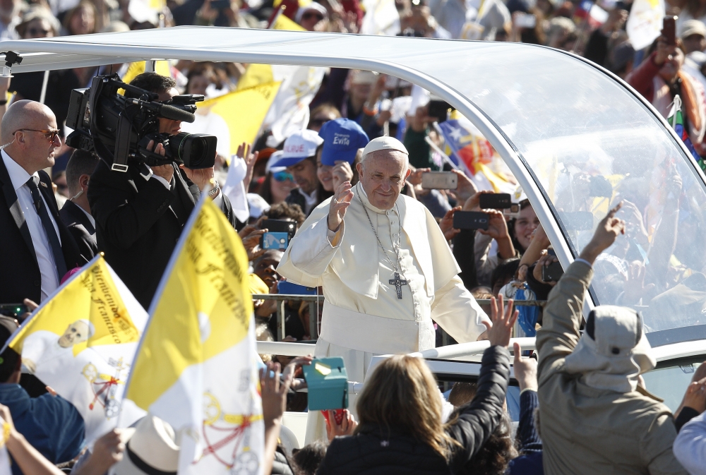 Pope Francis greeted the crowd before celebrating Mass Jan. 17 at the Maquehue Airport near
Temuco, Chile.