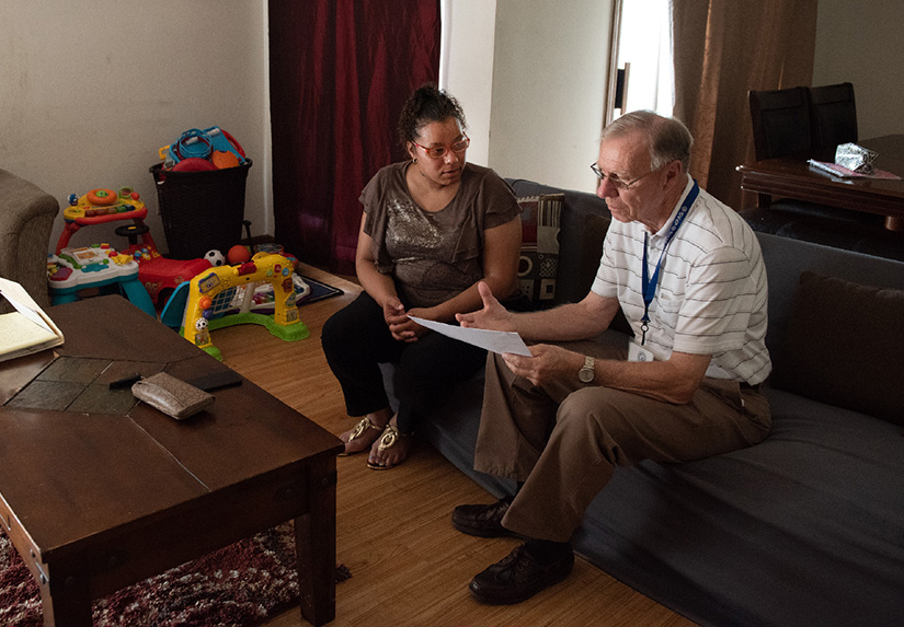 Ken Kapeller, right, of the Society of St. Vincent de Paul at St. Charles Borromeo Parish, conducted a home visit June 12 with Mellissa Gaines, who has received aid through the Society.