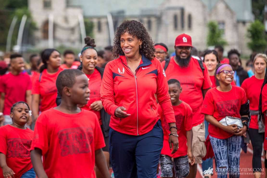 Jackie Joyner-Kersee jogged along with runners at Francis Field on June 22. Joyner-Kersee was speaking at an Olympic Day held at Washington University.
