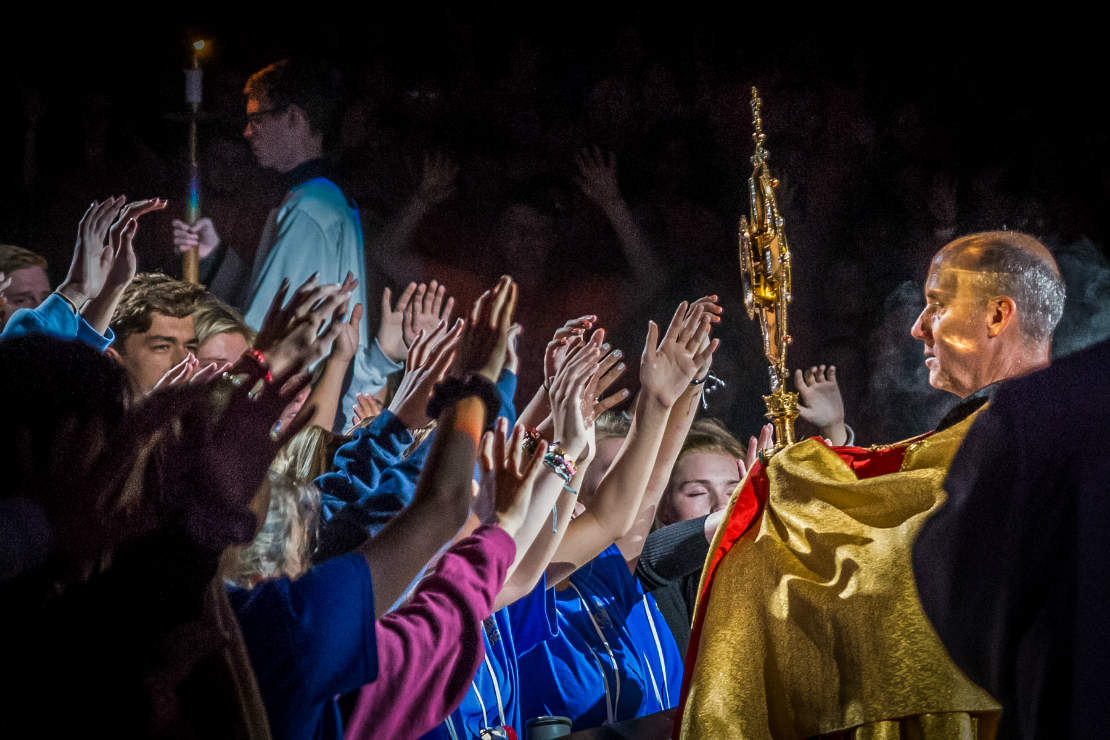 Father Dave Pivonka, TOR, processed the Blessed Sacrament through the crowds of SteubySTL Week 1 on Saturday night, blessing section by section. Father Pivonka was one of the hosts of Steubenville STL Mid-America, hosted annually by the archdiocese in Springfield, Mo.