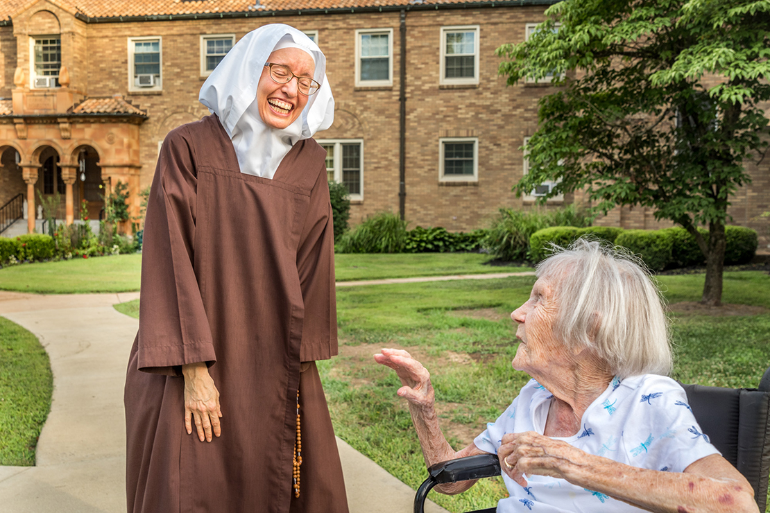 Sister Helen Marie of the Holy Eucharist talked with 94-year-old Catherine Rozycke before the start of the Novena to Our Lady of Mount Carmel on July 19. Rozycke, a parishioner at Queen of Peace in Belleville, Ill., has attended the annual outdoor novena for the entire 70 years it has existed.