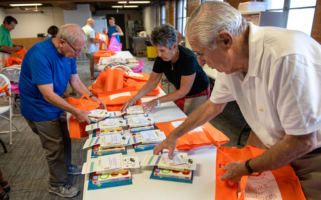 Richard Nix, right, began Books for Newborns with several other people to address the connection between a lack of literacy and poverty. The nonprofit provides low-income mothers with a free tote bag filled with four new books, along with resources to help mothers bond with their children.