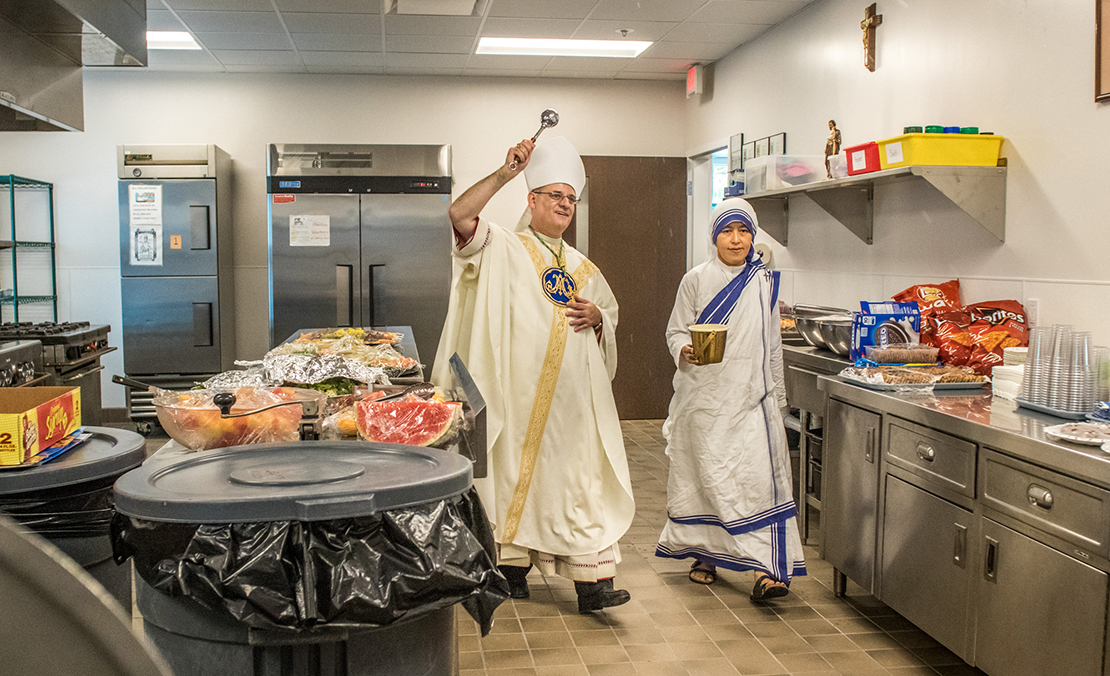 Sister M. Jonathan, Midwest regional superior, assisted Auxiliary Bishop Mark S. Rivituso as he blessed the new Missionaries of Charities’ soup kitchen in north 
St. Louis after Mass Aug. 16.