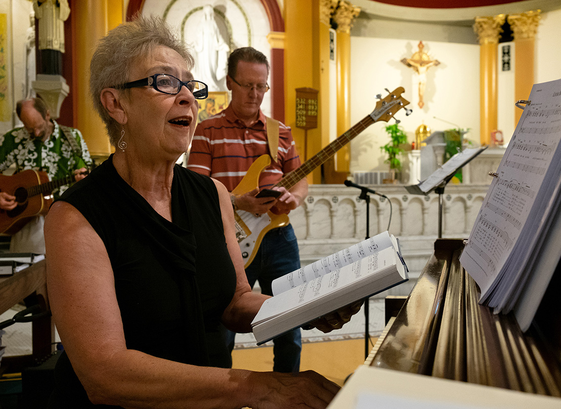 Ruth Ehresman, director of the St. Pius V Church choir, played the piano as the choir members practiced before Mass at the church. “We have a wonderful group of folks in the choir who enjoy singing, are committed and enjoy leading the singing,” Ehresman said.