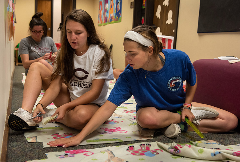 Villa Duchesne students Maria Adamitis, left, and Clare Eisenbeis worked on blankets to be distributed to the needy during the school’s Global Service Day Sept. 15 in Frontenac. The service day, involving 147 Sacred Heart Schools in 33 countries, marked the 200th anniversary of St. Rose Philippine Duchesne opening the first Sacred Heart School in North America. Participants filled and delivered blessing bags with essential personal supplies, cleaned up campus and volunteered at the St. Louis Area Foodbank.