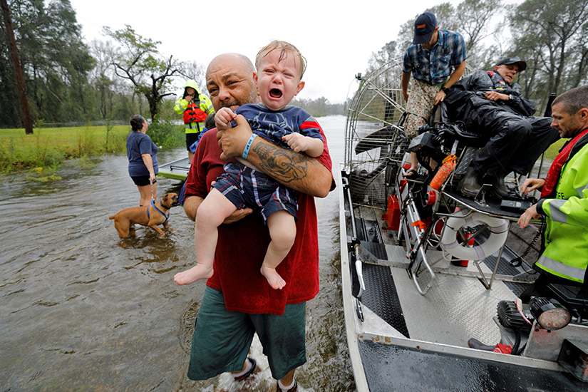 One-year-old Oliver Kelly cried as he was carried off a sheriff’s airboat in Leland, N.C., during a rescue Sept. 17 from rising floodwaters in the aftermath of Hurricane Florence. The storm dumped record rainfall on the Carolinas, causing record flooding in many areas of the states.
