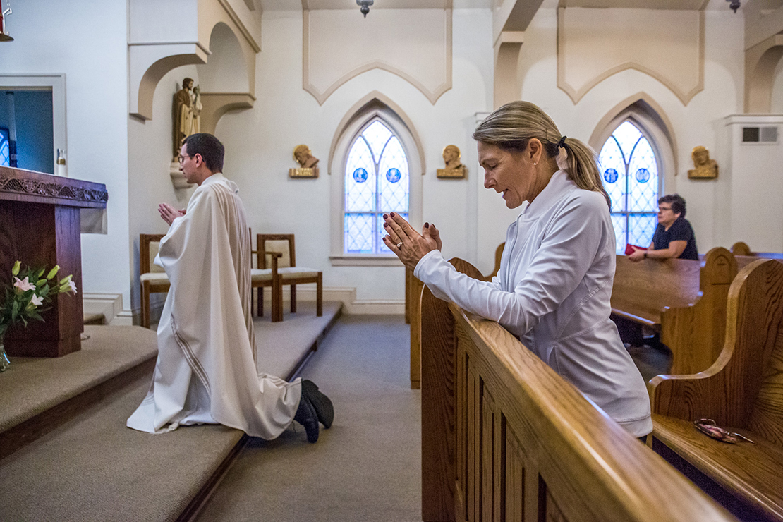 Barb Kelley starts her day at 4 a.m. with prayer and then attends morning Mass at Ascension Parish’s “Little Church.” She knelt in the front pew as Father Michael Lampe prayed the St. Michael prayer following Mass on Oct. 2. In healing from her own divorce, Kelley said she needed “God my Father and my Redeemer in my life.”
