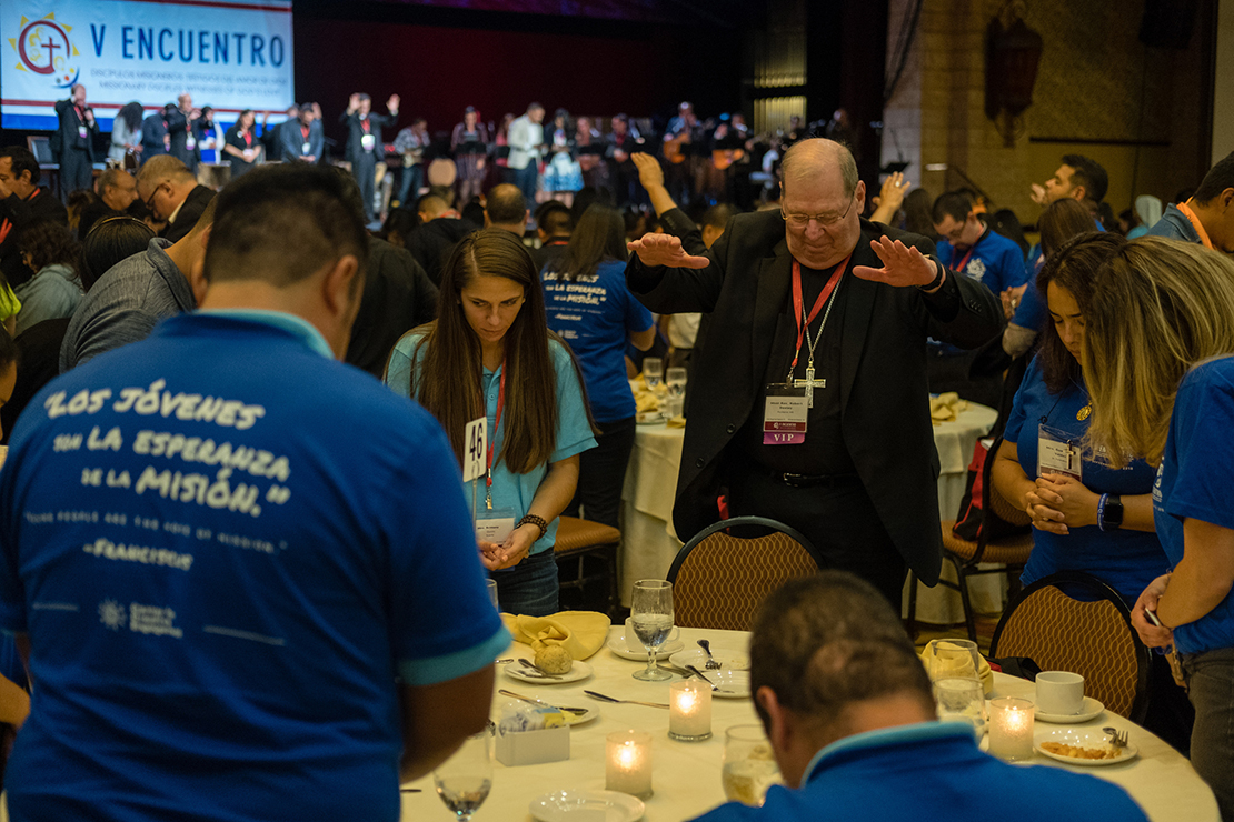 Bishop Robert P. Deeley of Portland, Maine, prayed with young adults Sept. 21 at an evening encounter at the Fifth National Encuentro in Grapevine, Texas. The dinner brought together more than 700 Catholic young adults and a cross section of the 150 bishops attending the national event.