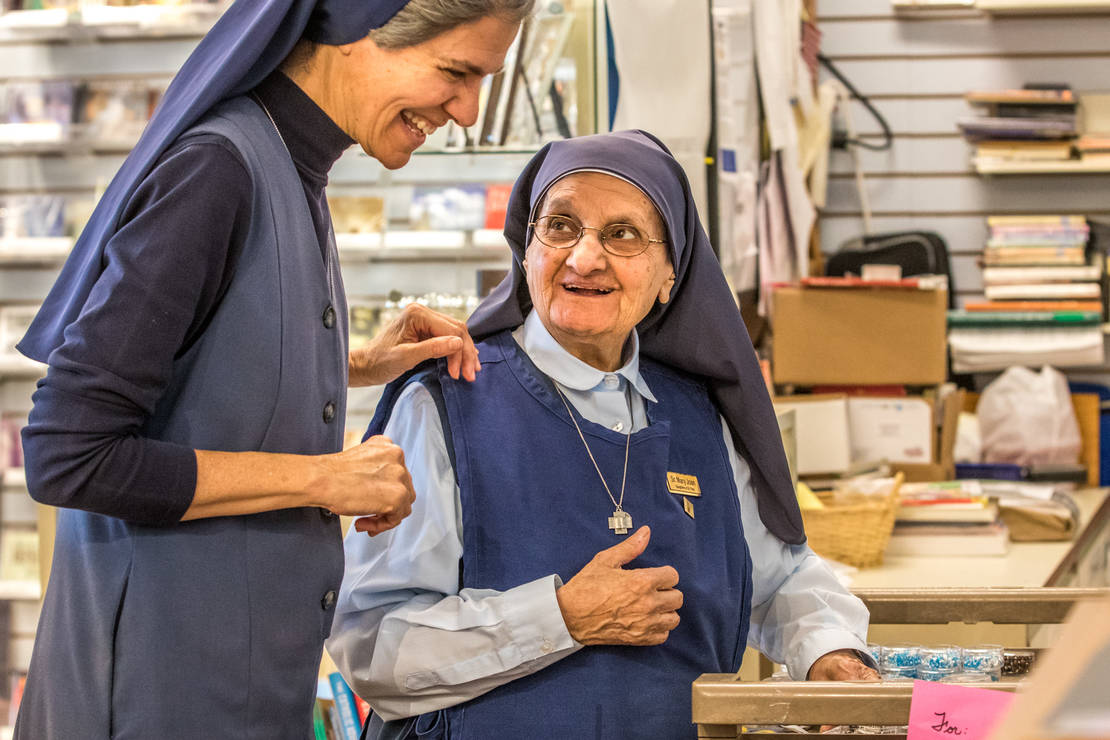 Sister Mary Joan Baldino, FSP, right, at age 89, is past the standard retirment age, but still finds time to serve at Pauline Books & Media in Crestwood. She priced rosaries with Sister Laura Brown, FSP, on Oct. 23 at the store.