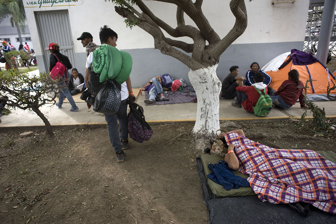 A man slept on the grounds of a sports facility in Tijuana, Mexico, set up for people arriving Nov. 15 in a caravan of Central American migrants at the U.S.-Mexico border. The shelter opened the previous night and had more than 750 people, but dozens more lined up outside waiting to enter.