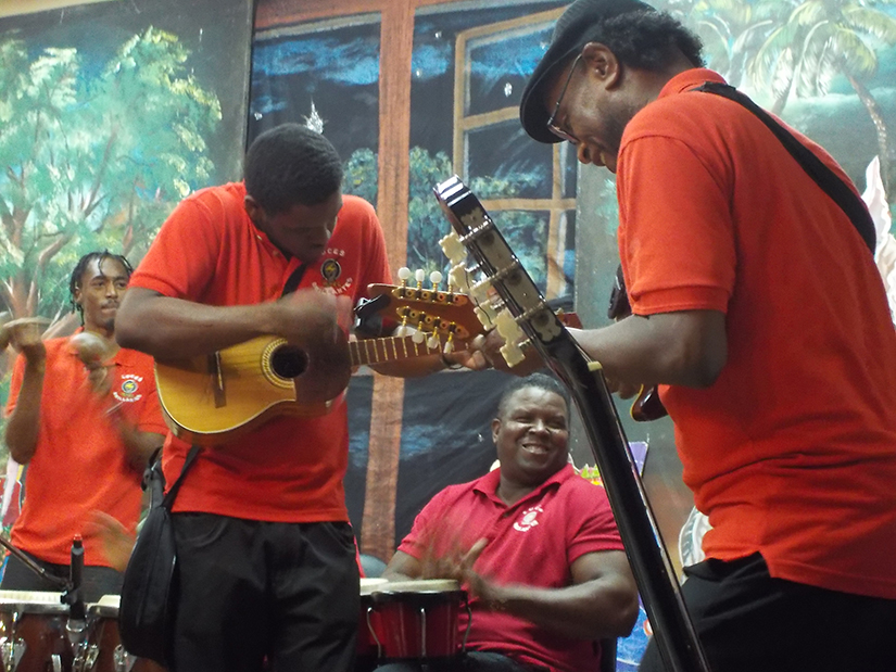 Julio Torres, veteran parang musician and vocal coach who mentors young men, right, performed during the Luces Brilliantes fundraiser performance Nov. 18 at St. Theresa Parish in Barataria, Trinidad and Tobago.