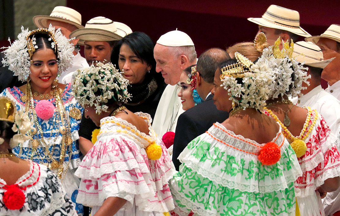 Pope Francis walked past people in traditional clothing at his general audience in Paul VI Hall Dec. 12. Before the audience, the pope blew out candles on a cake a visitor had prepared. The pope will celebrate his 82nd birthday Dec. 17.