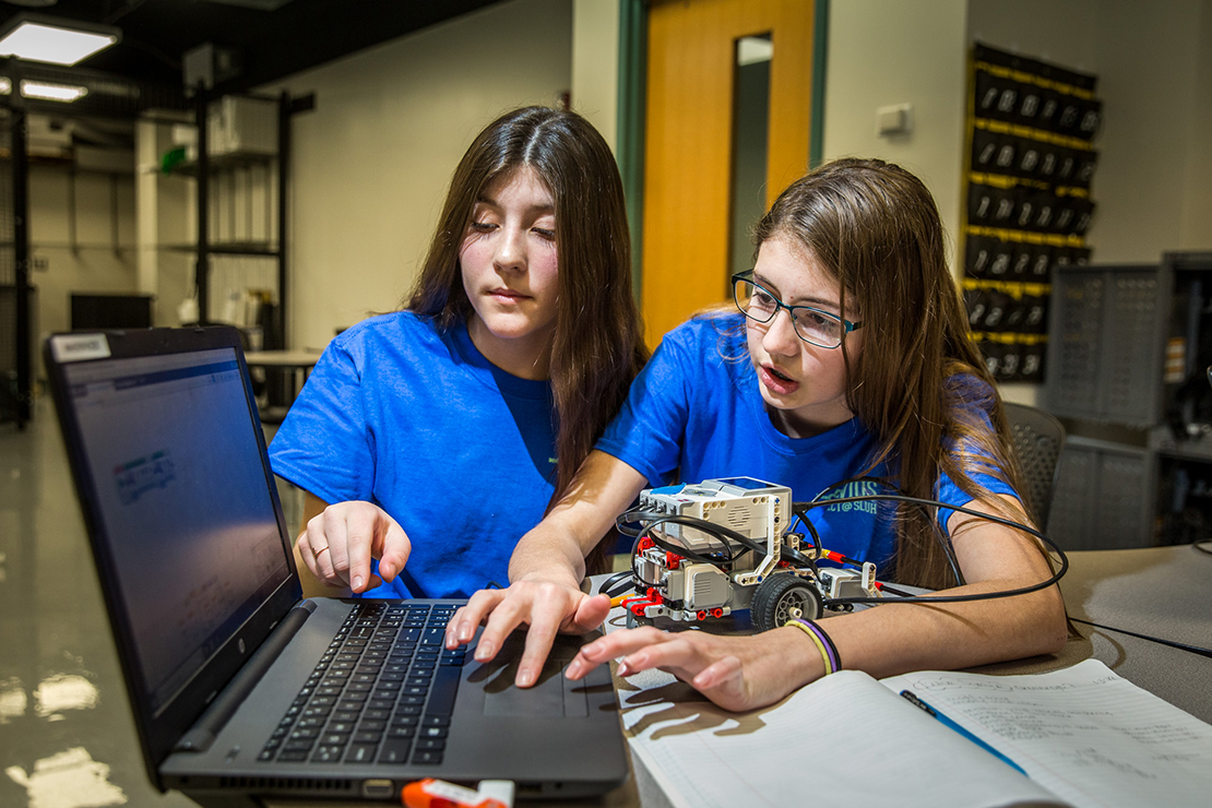 Gianna Schurk, left, and Isabella Johnston programmed their robot named CALI (Cool, Amazing, Lego Intelligent) Jan 29 at St. Joseph School in Imperial. With help from the Clavius Project at SLUH, the school started robotics last year.