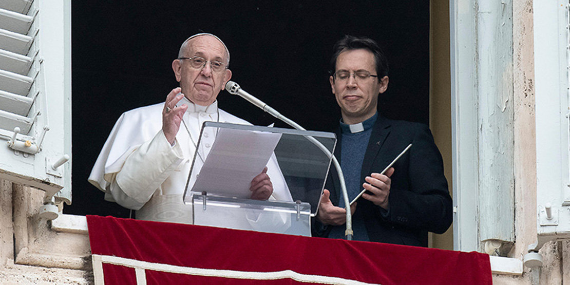 Pope Francis stood neext to Jesuit Father Frederic Fornos, head of the Pope’s Worldwide Prayer Network, during the Angelus led from the window of his apartment overlooking St. Peter’s Square at the Vatican Jan. 20. The pope used a tablet held by Father Fornos to launch “Click to Pray,” a new mobile app and online platform.
