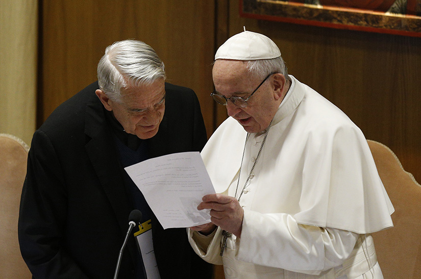 Pope Francis talked with Father Federico Lombardi at the start of the third day of the meeting on the protection of minors in the church at the Vatican Feb. 23.