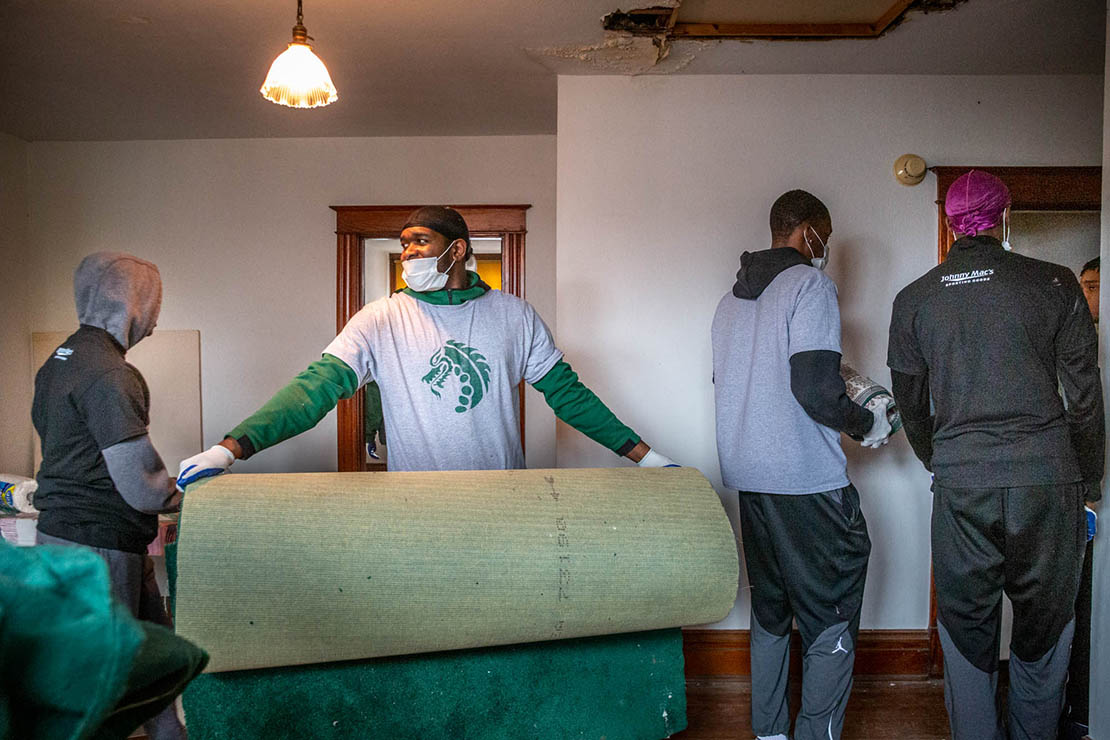 The St. Joseph Housing Initiative began work on a south St. Louis home on March 2. Damond Wiley carried a piece of carpet as the basketball team from St. Mary’s High School volunteered to clean out the house the day after they won the district basketball championship. 