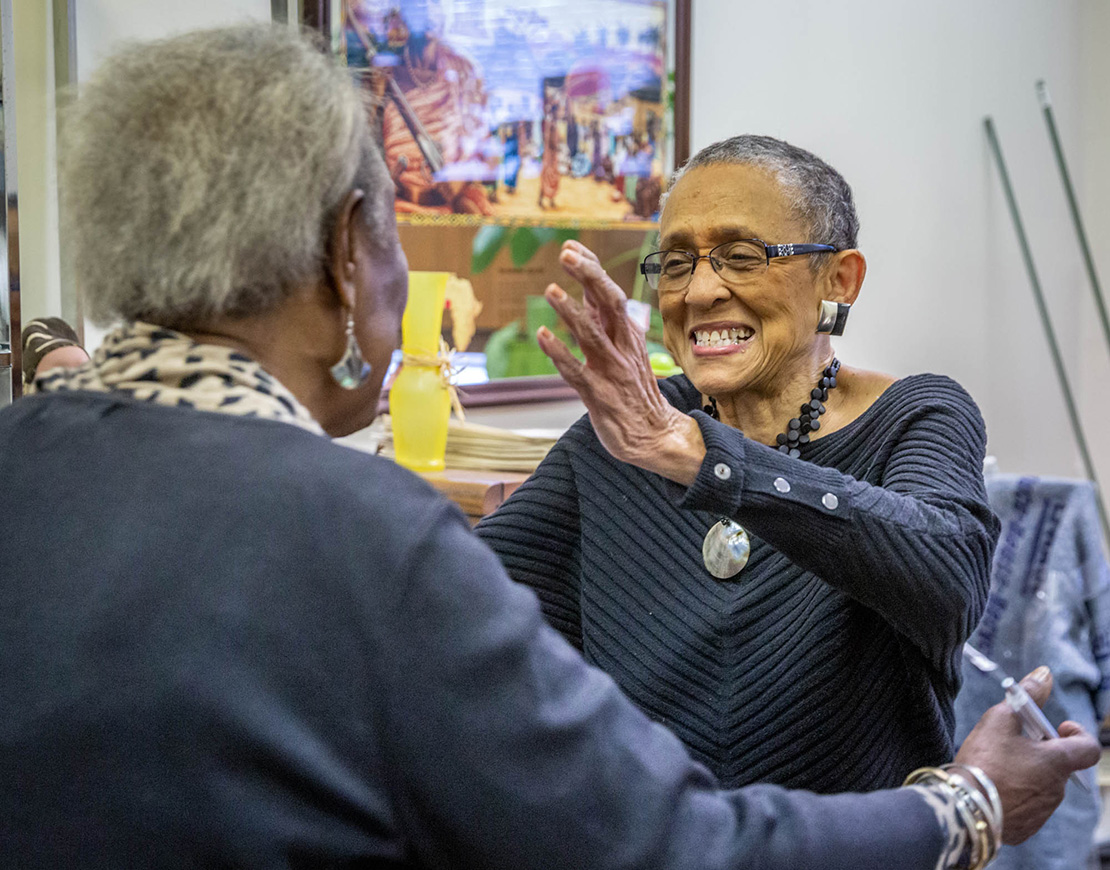 Gloria Taylor, co-founder of Community Women Against Hardship, spoke with longtime friend and social worker Bernice Thompson at the organization’s Family Support Center in the Vandeventer neighborhood of St. Louis. Community Women Against Hardship was honored with the Torchbearer Award by the St. Charles Lwanga Center.
