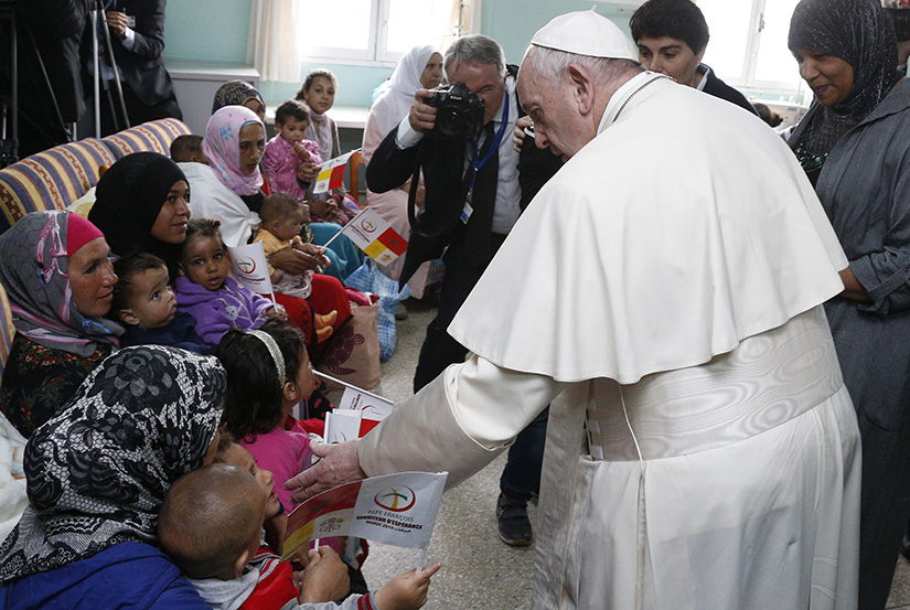 Pope Francis greeted family members as he visited the Rural Center for Social Services at Temara, south of Rabat, Morocco, March 31.