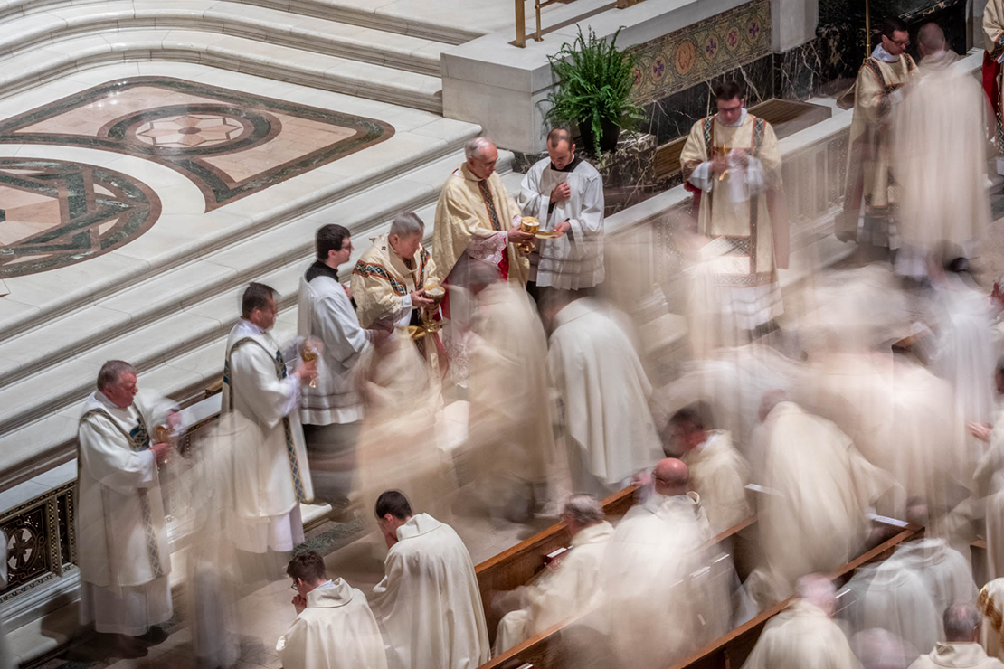 Priests received Communion during the Chrism Mass April 18 at the Cathedral Basilica of Saint Louis.