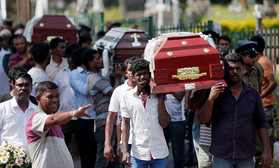 People carried the caskets of victims during a mass burial for victims of bomb attacks in Colombo, Sri Lanka, April 23. More than 250 people were killed in a string of suicide bomb attacks on churches and luxury hotels across the island April 21.