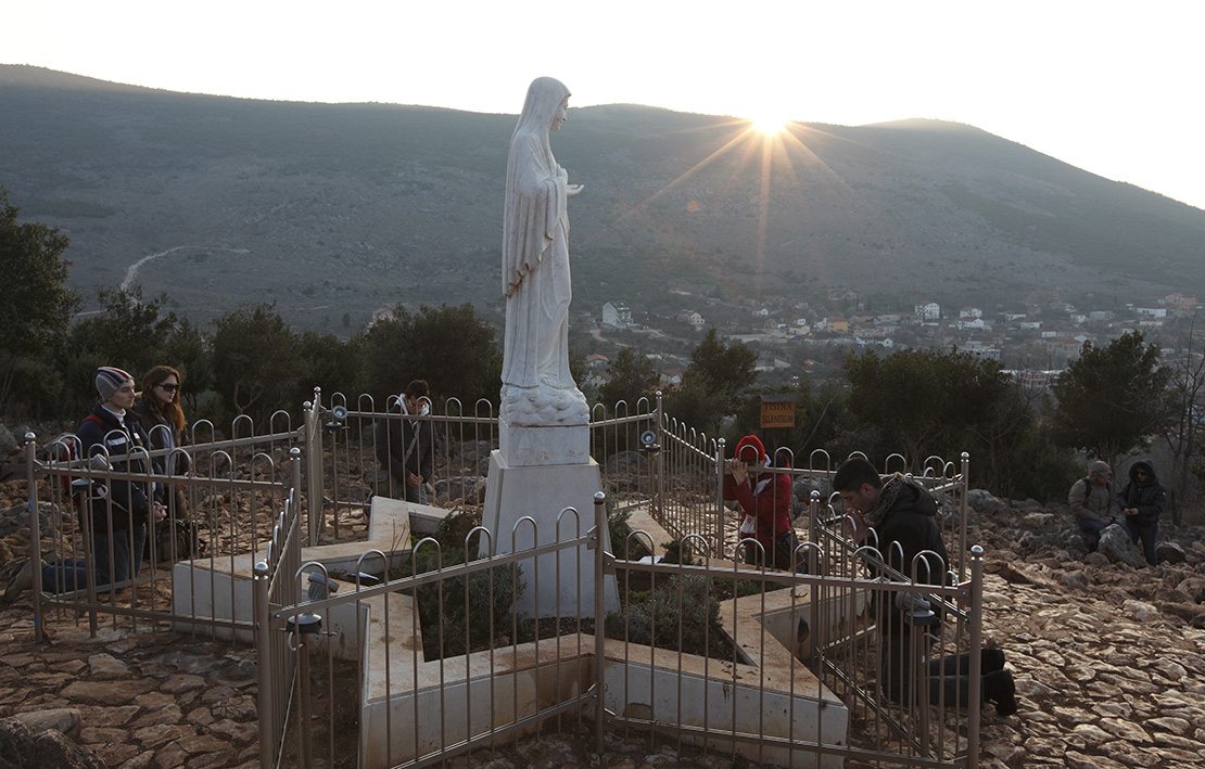Pilgrims prayed near a statue of Mary on Apparition Hill in Medjugorje, Bosnia-Herzegovina, in 2011. Pope Francis has decided to allow parishes and dioceses to organize official pilgrimages to Medjugorje; no decision has been made on the authenticity of the apparitions.