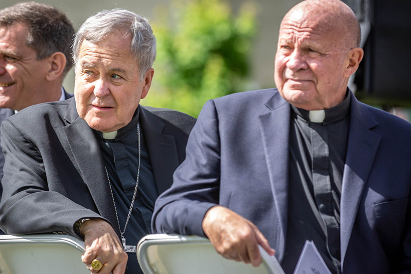Archbishop Robert J. Carlson and president emeritus of St. Louis University, Father Lawrence Biondi, SJ, turned to look at the unveiled street sign along Grand Avenue showing the road was honorarily named after Father Biondi.