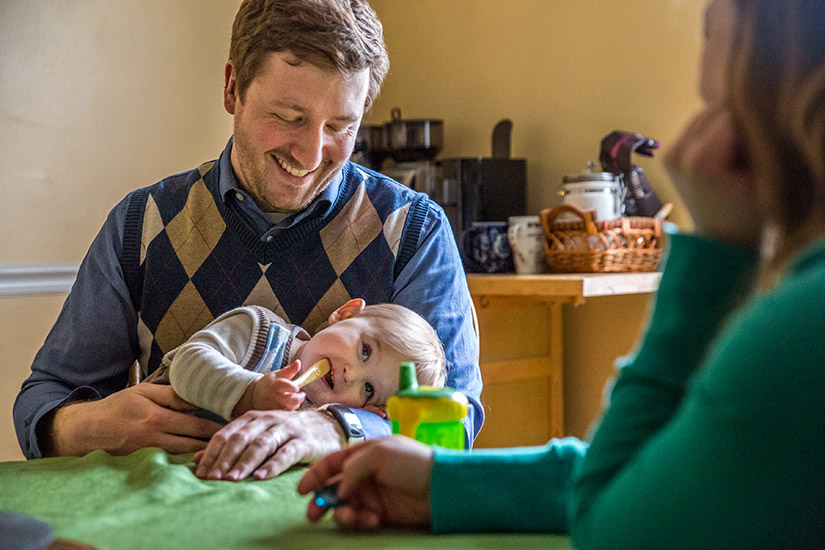 Steven and Liz Callen sat at their kitchen table with their son, Simon, in 2018. The Callens
received a grant from the Archbishop Robert J. Carlson Adoption Fund to help in their adoption.