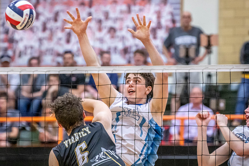 St. John Vianney High School's Alex Whitesides hit the ball as St. Louis University High School's Andrew Cross guarded the net. SLUH beat Vianney to win the Class 4 volleyball state championship.