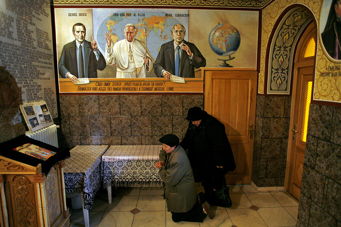 People prayed at an Orthodox church with portraits of former U.S. President George Bush, Pope John Paul II and ex-soviet leader Mikhail Gorbachev painted on the walls in the village of Petresti, 205 miles northwest of Bucharest, Romania, in 2008. Pope Francis is scheduled to visit Romania May 31-June 2.
