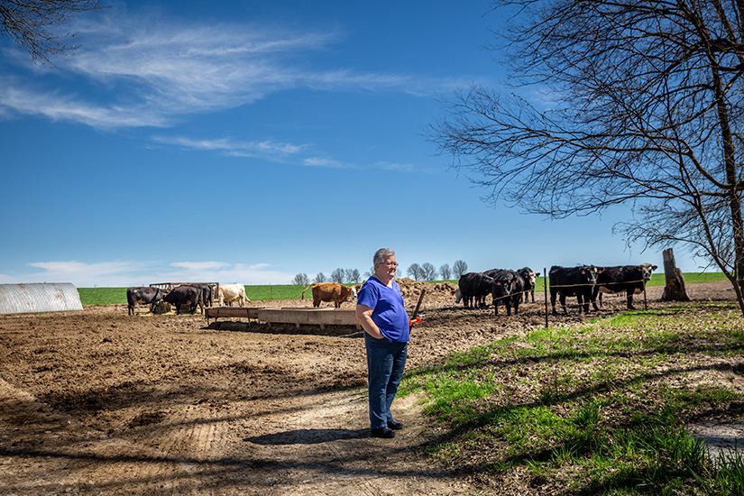 Barb Schneider looks over her family farm in Warrenton in April. The Schneider family are parishioners at Holy Rosary in Warrenton, which has been serving farming families in Warren County since it began as a mission church in 1865.