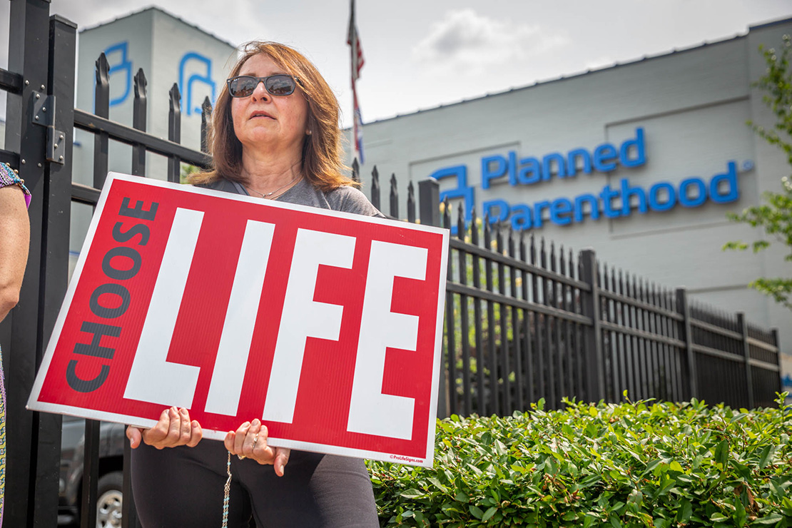Donna Bambao, a parishioner from the Oratory of St. Francis de Sales, stood along the fence at Planned Parenthood in St. Louis May 31.