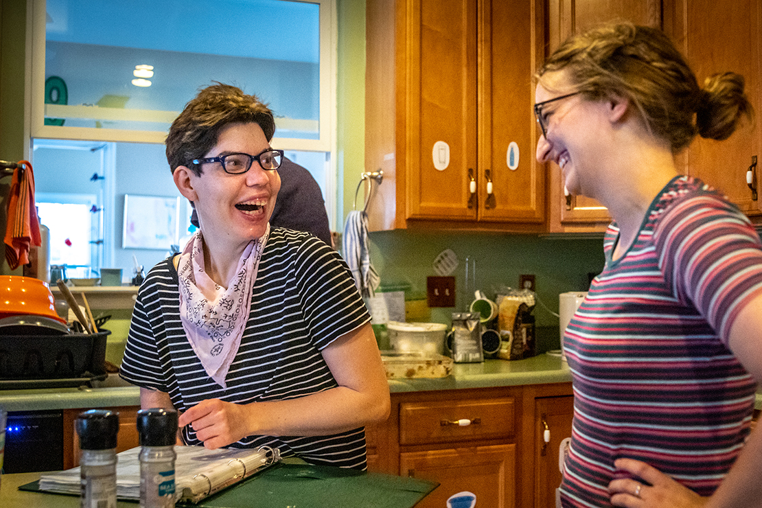 Kira Brandt, left, and Kristina Roselle worked in the kitchen at a L’Arche home in St. Louis July 1. L’Arch is a community in which adults with disabilities live with assistants and share share day-to-day activities, including meals and chores.