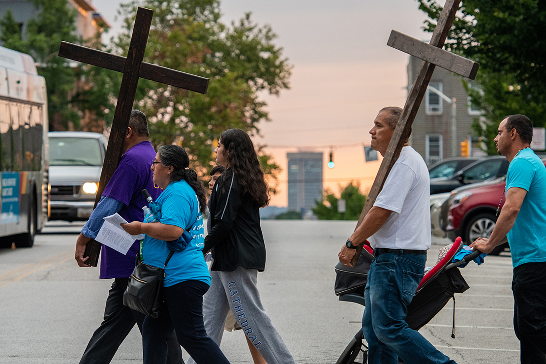 Particpants carried crosses in the refugee-themed Stations of the Cross in Baltimore July 23. More than 200 people participated in the event which included prayer for refugees and migrants and reflections at each station.