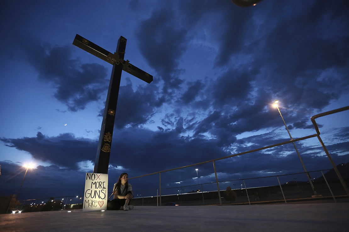 A woman was among those who held a vigil in Juarez, Mexico, Aug. 3, for the 3 Mexican nationals who were killed in an El Paso shopping complex.