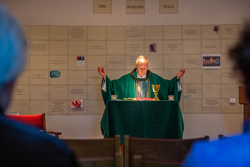 Msgr. Jack Schuler celebrated Mass Aug. 17 in the chapel at St. Cronan Parish in St. Louis. The parish created a wailing wall behind the altar with written prayers and reflections on the issue of clergy sexual abuse.