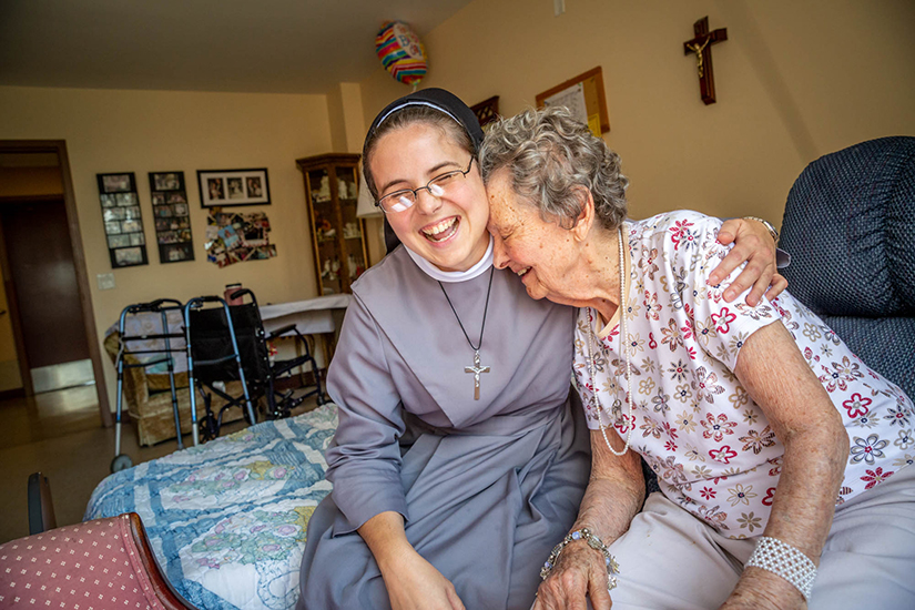 Sister M. Stella Maris Larkin, FSGM, visited with Mary Jane Niemann, 94, at the Mother of Good Counsel Home on Sept. 12.