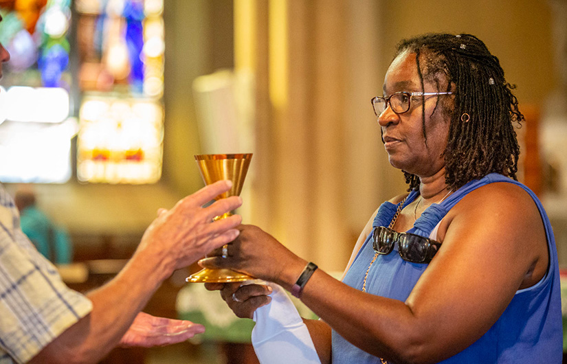 Brenda Tillman distributed the Precious Blood during Mass at Most Holy Trinity Church on Sept. 15.