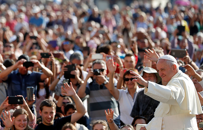 Pope Francis greeted pilgrims as he arrived for his general audience in St. Peter’s Square at the Vatican Oct. 2.