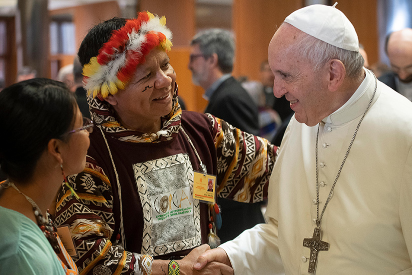 Pope Francis greeted people during the Synod of Bishops for the Amazon at the Vatican Oct. 8.