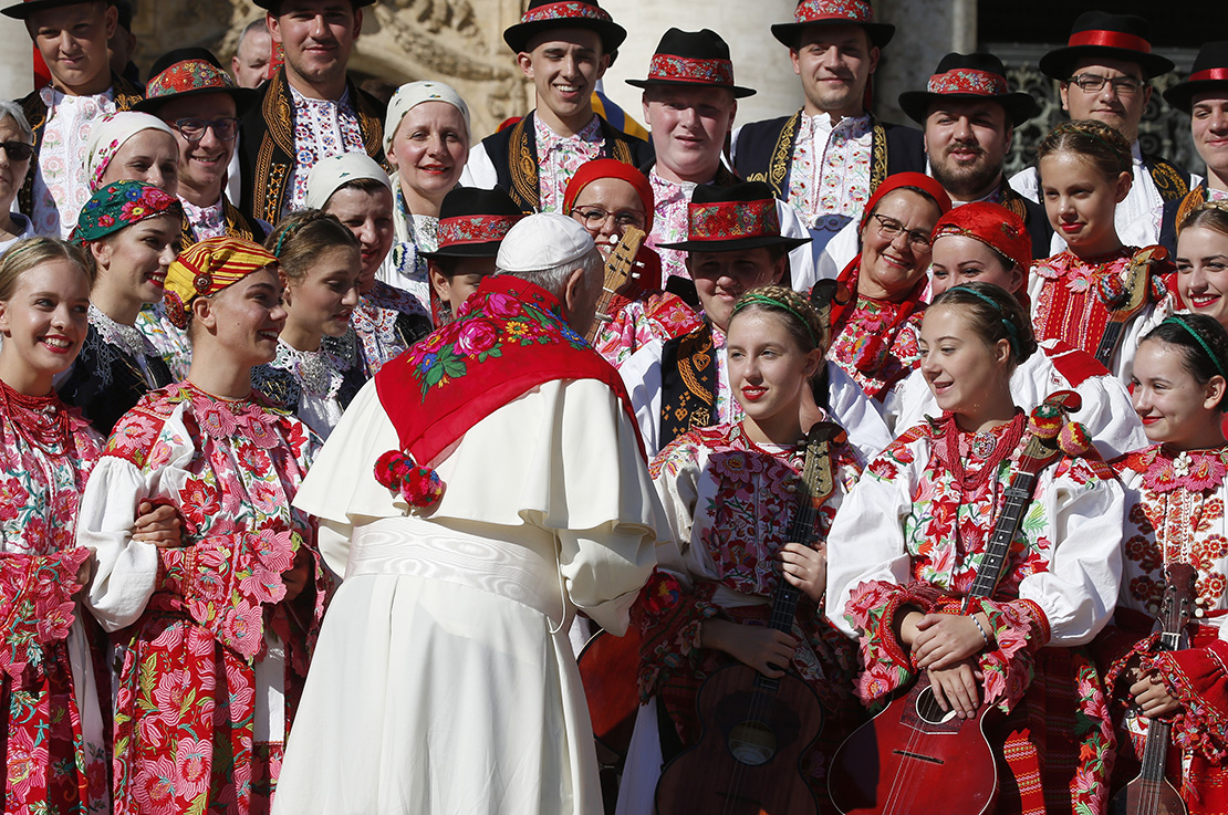 Pope Francis spoke with members of a dance group from Croatia during his general audience in St. Peter’s Square at the Vatican Oct. 9.