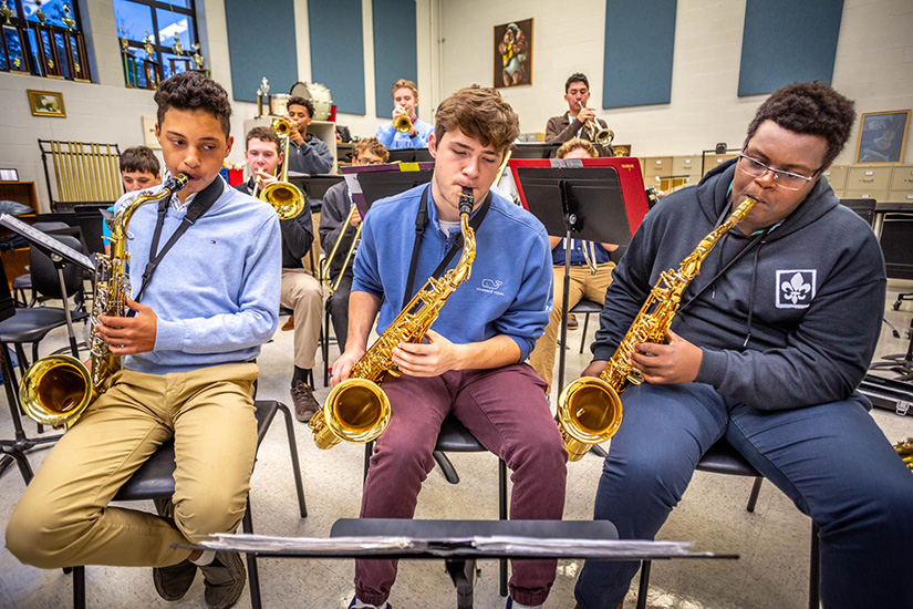 Cody Cox, Aiden Lundergan and David Thuita played the tenor saxophone with members of the Saint Louis University High School jazz band Oct.21 as they practiced for an upcoming performance.
