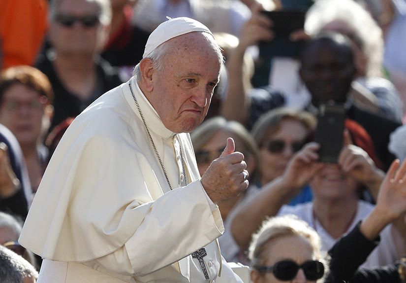 Pope Francis gave a thumbs-up as he greeted the crowd during his general audience in St. Peter’s Square at the Vatican Oct. 16.