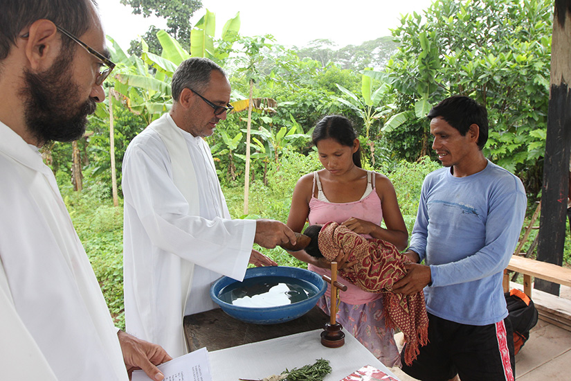 Father Miguel Angel Cadenas, a Spanish Augustinian missionary, baptized an infant in an Urarina indigenous community on Peru’s Urituyacu River.