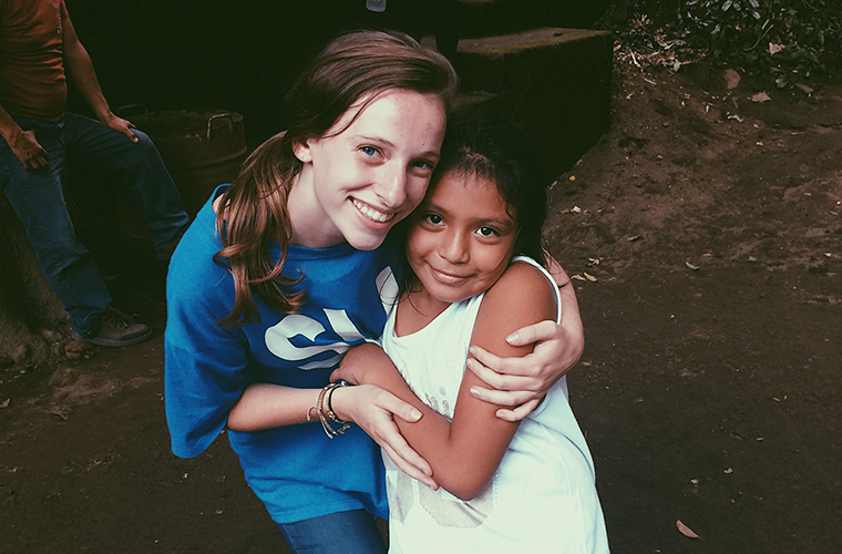 Suzy Kickham visited with a 7-year-old friend she made while volunteering in a children’s program in a village in Nicaragua. Kickham, a St. Louis University student, said she appreciated the beauty and challenges she found in the Central American country thanks to a program in memory of a 1985 graduate of SLU, Mev Puleo.