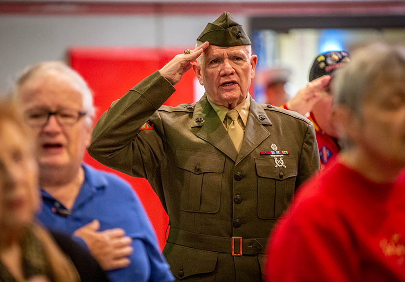 Retired U.S. Marine Corps Sgt. Mike Sappington saluted during the pledge of allegiance at a program honoring military veterans at St. Matthias Catholic Church on Nov. 11.