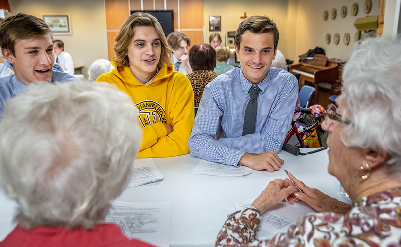 Nick Pinkston, Collin Wobbe and John Allen, students from St. John Vianney High School, visited Jeanette Kouba and Mary Ann Carmody to teach them about cyber security at Our Lady of Life Apartments on Oct. 29.