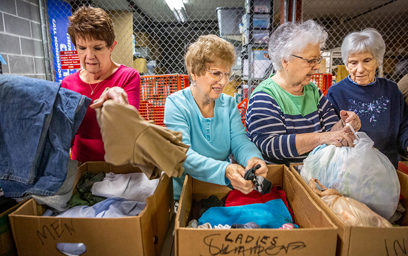 From left, Judy Brusselback, Gerri Zeman, Linda Winkler and Anna Brueckner joined the other “Rag Ladies” in sorting and boxing donations at Queen of All Saints Parish in Oakville Nov. 4. The Rag Ladies sort through donations to the parish’s St. Vincent de Paul Society to ensure they are in good condition and then organize them.