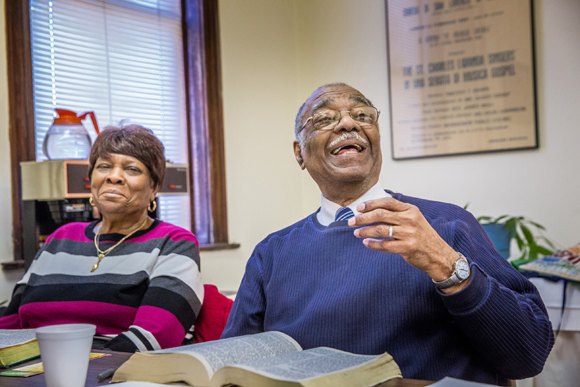 Queen Esther Frazier, left, and Richard Watkins enjoyed a lively discussion at a Bible study group at the St. Charles Lwanga Center two years ago. Frazier still attends the center’s Bible study with Father Art Cavitt each week.
